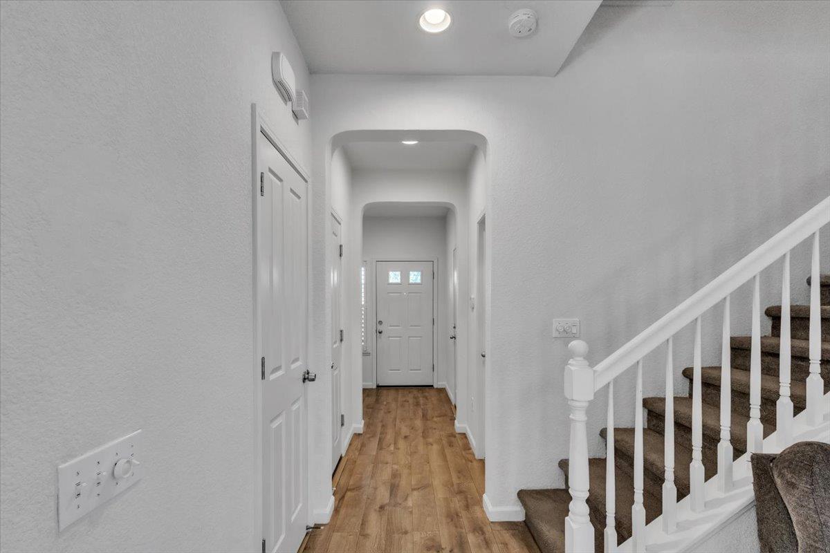 2608 Greenleaf Street Manteca, CA 95337 - Photo 6 of 65 a view of a hallway with wooden floor and staircase