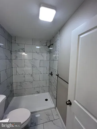 a bathroom with a toilet and shower