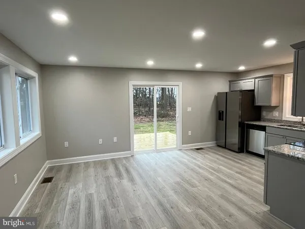 a view of a kitchen with a sink and a refrigerator