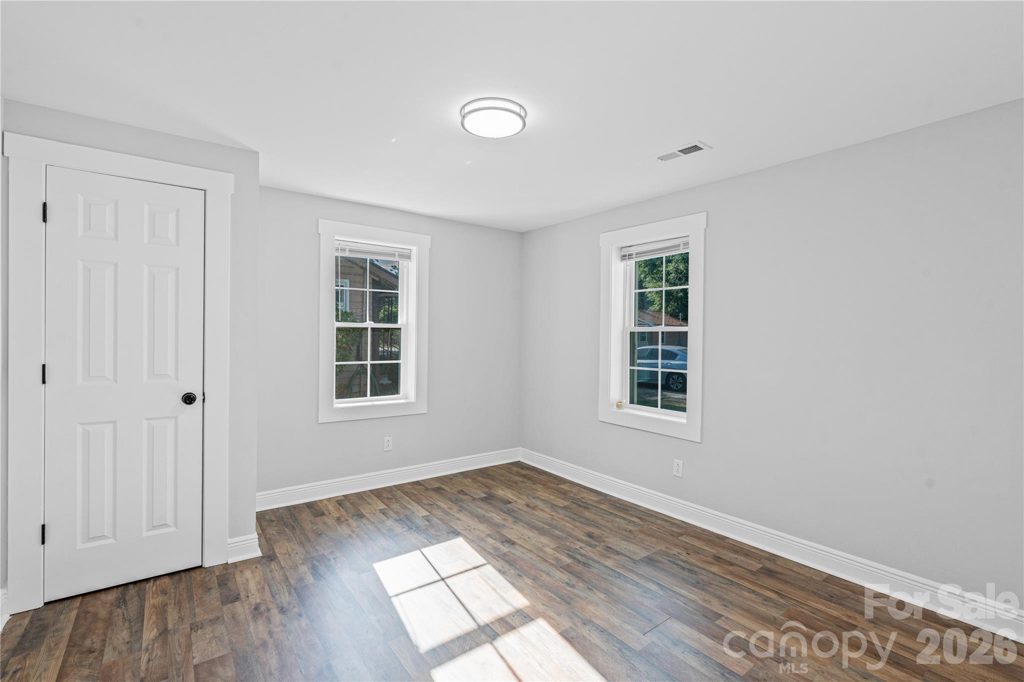 906 Gladstone Street Florence, SC 29501 - Photo 9 of 15 an empty room with wooden floor and windows