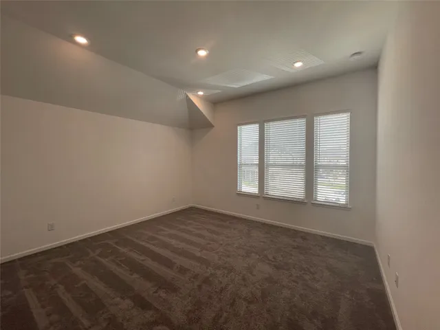 an empty room with a empty space and windows