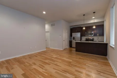 a view of kitchen with refrigerator and window