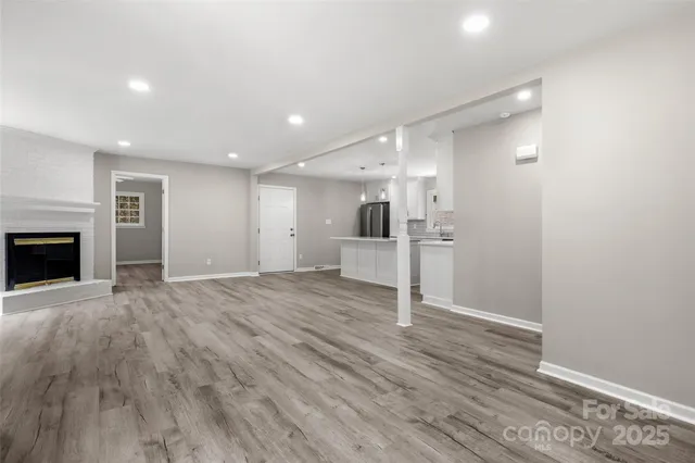 a view of a kitchen with a sink and a refrigerator