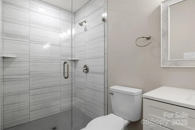 a bathroom with a toilet and a shower