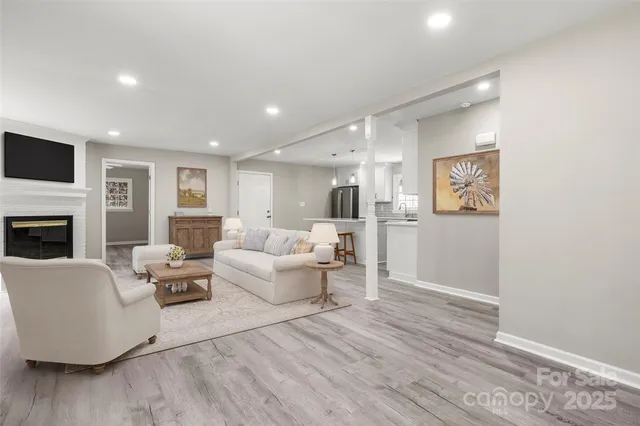 a living room with furniture and a fireplace