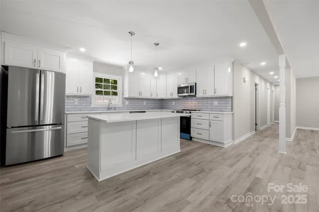 a kitchen with a white cabinets and stainless steel appliances