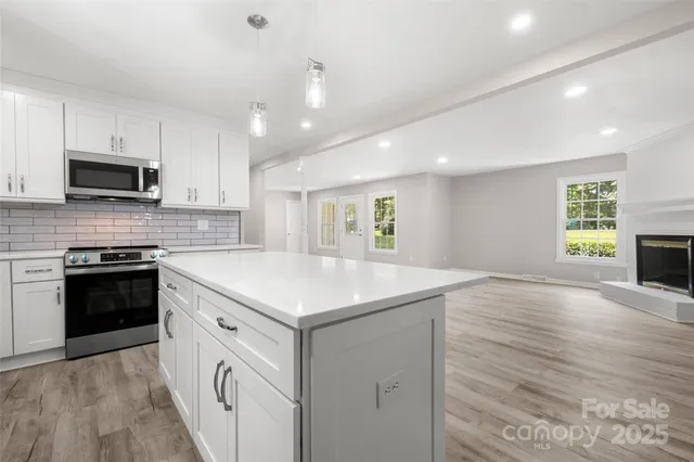 a kitchen with a stove a sink and a microwave