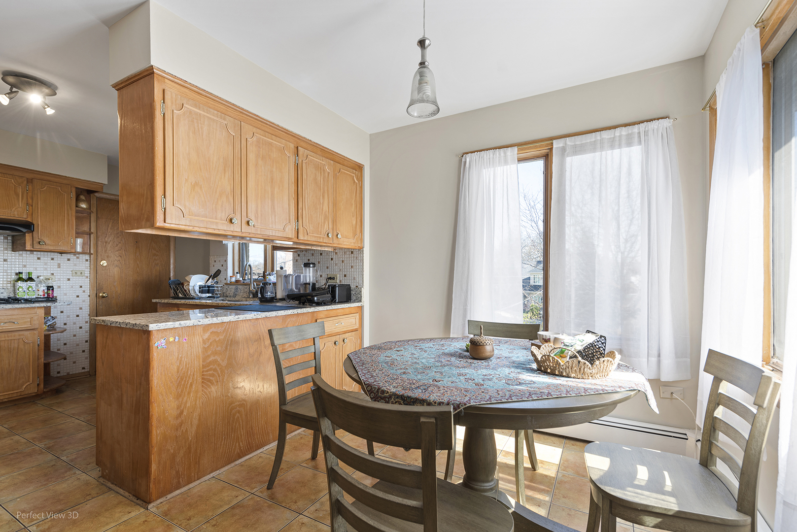 1121 North Northwest Highway Park Ridge, IL 60068 - Photo 16 of 26 a kitchen with stainless steel appliances granite countertop a stove a sink dishwasher and microwave with wooden table