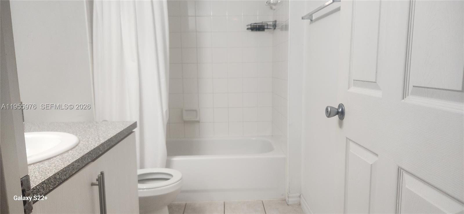 5011 Wiles Road, Unit 306 Coconut Creek, FL 33073 - Photo 16 of 17 a bathroom with a granite countertop sink a toilet and shower