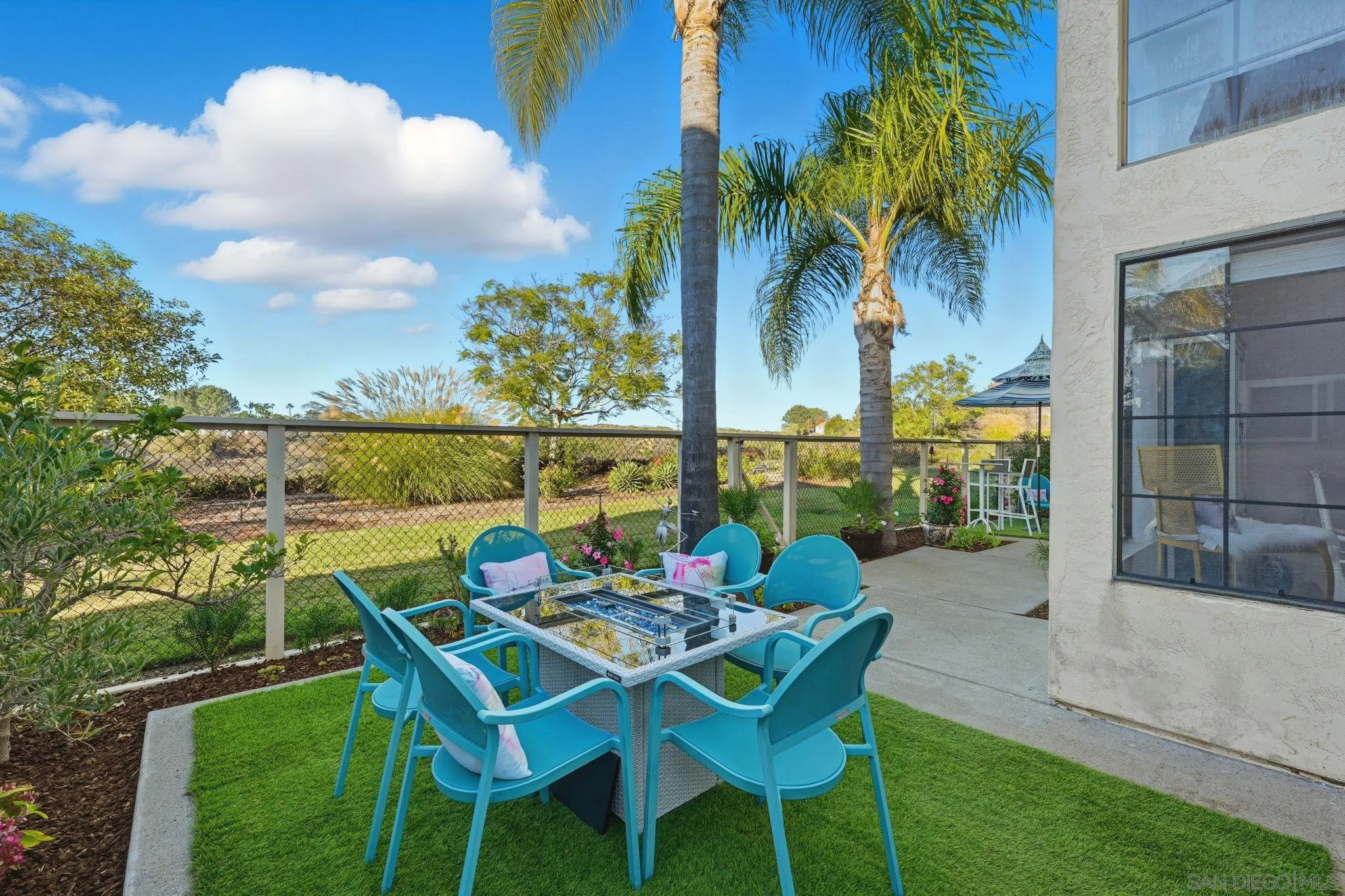3626 Lorimer Lane Encinitas, CA 92024 - Photo 41 of 62 a table and chairs with the view of back yard