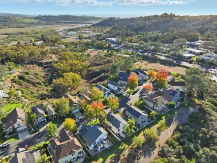 an aerial view of residential houses with outdoor space