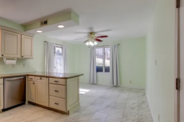 a kitchen with white cabinets stainless steel appliances and sink