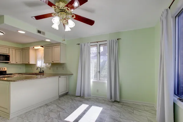 a view of wooden floor and windows in a room