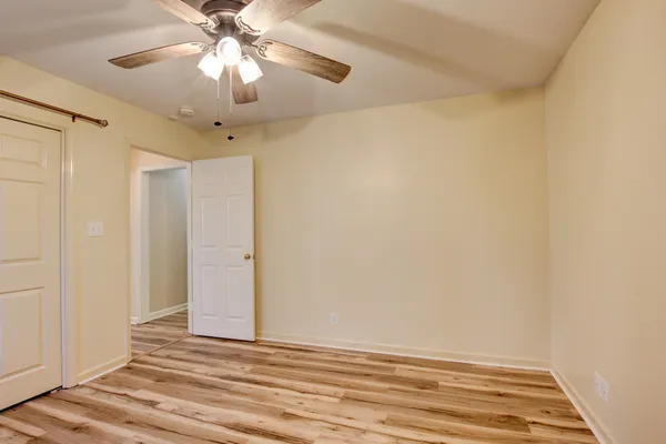 a view of a room with a ceiling fan