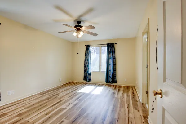 a view of an empty room and wooden floor