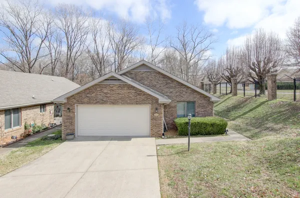 a view of a house with a yard and garage