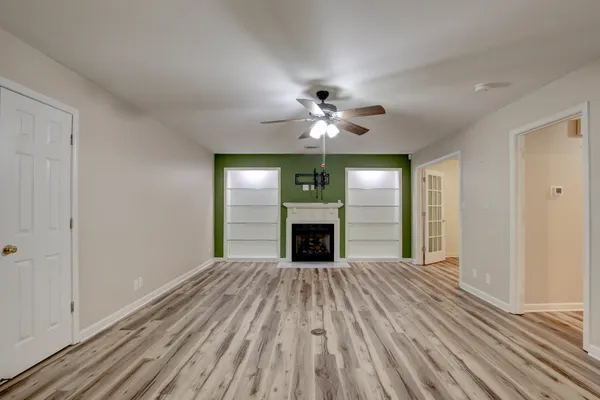 a living room with fireplace furniture and a wooden floor