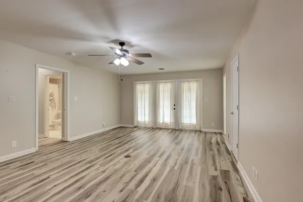 wooden floor in an empty room with a window