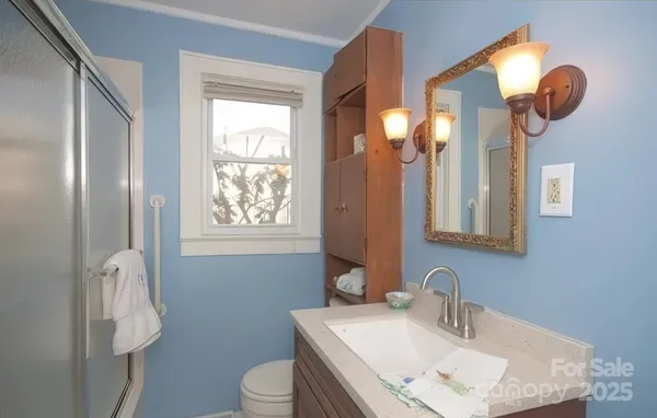 a bathroom with a toilet sink and mirror