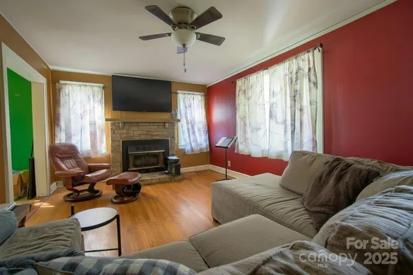 a living room with furniture a fireplace and a flat screen tv