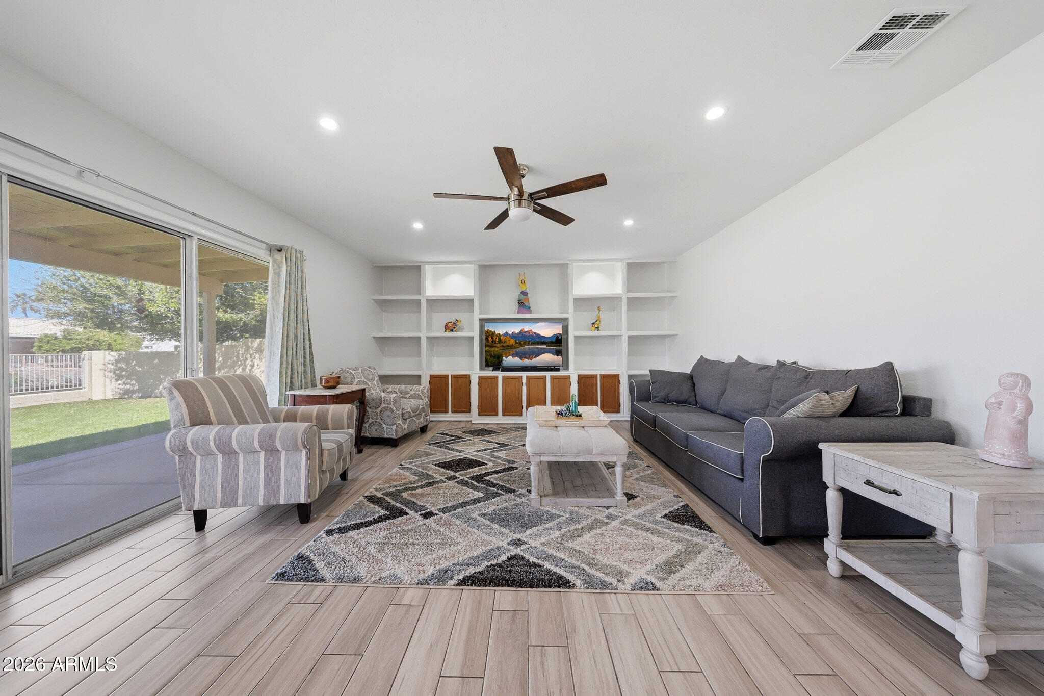 648 South Cholla Street Gilbert, AZ 85233 - Photo 12 of 46 a living room with furniture ceiling fan and a large window