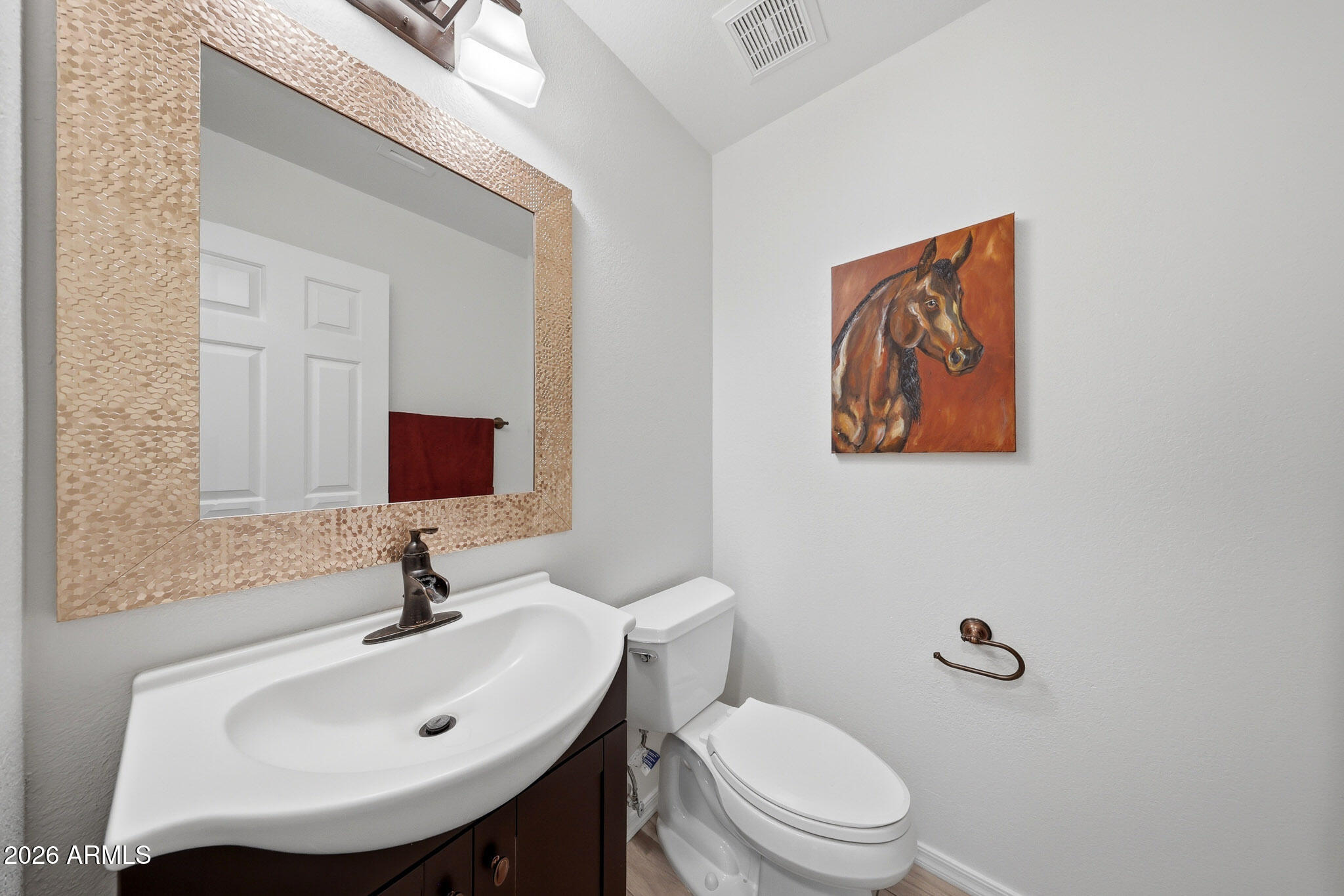 648 South Cholla Street Gilbert, AZ 85233 - Photo 15 of 46 a bathroom with a toilet sink and mirror