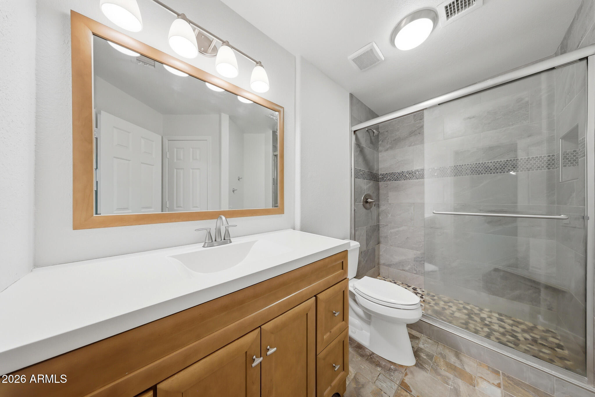 648 South Cholla Street Gilbert, AZ 85233 - Photo 18 of 46 a bathroom with a sink a toilet a mirror and shower