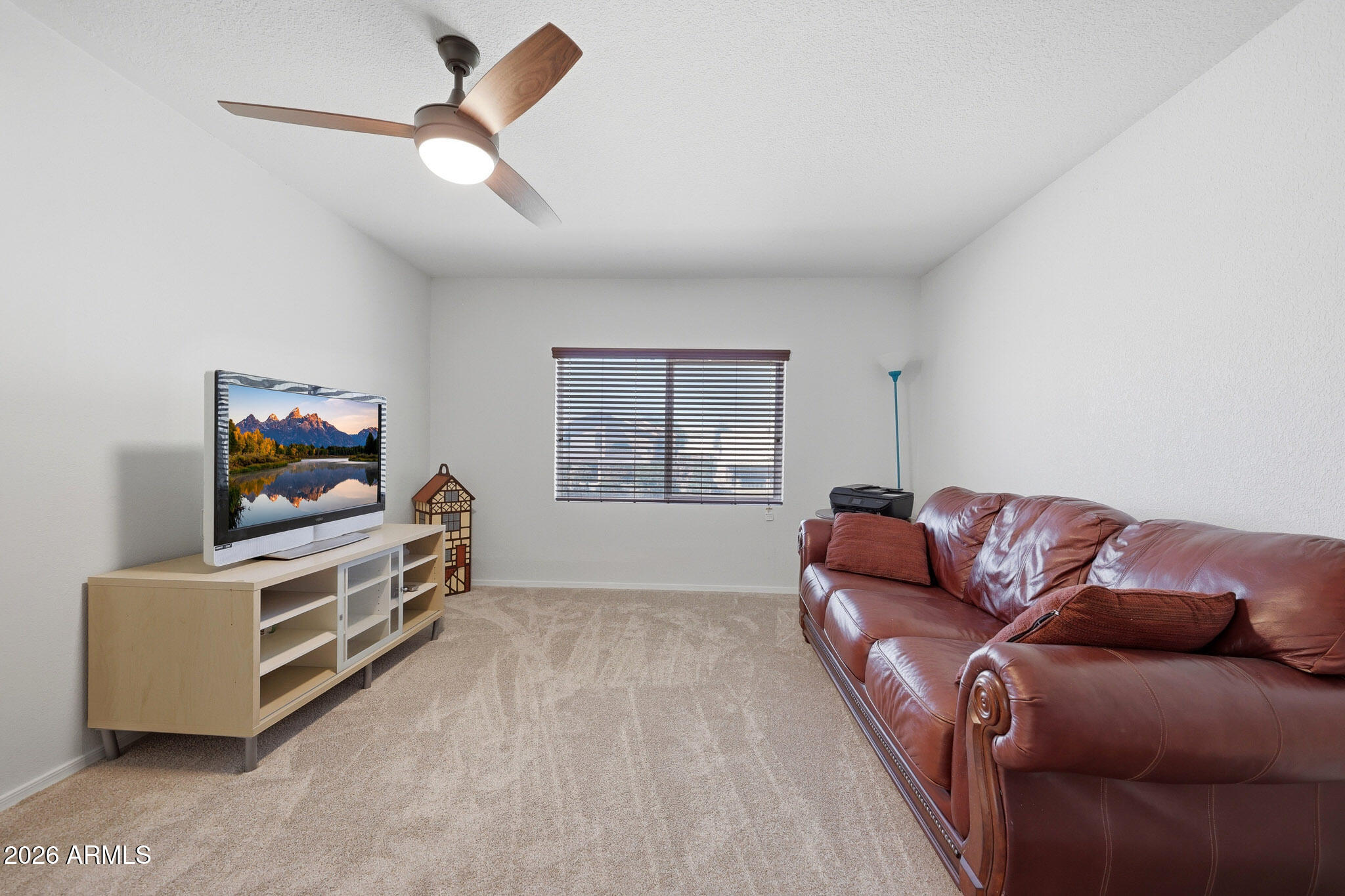 648 South Cholla Street Gilbert, AZ 85233 - Photo 35 of 46 a living room with furniture and a flat screen tv