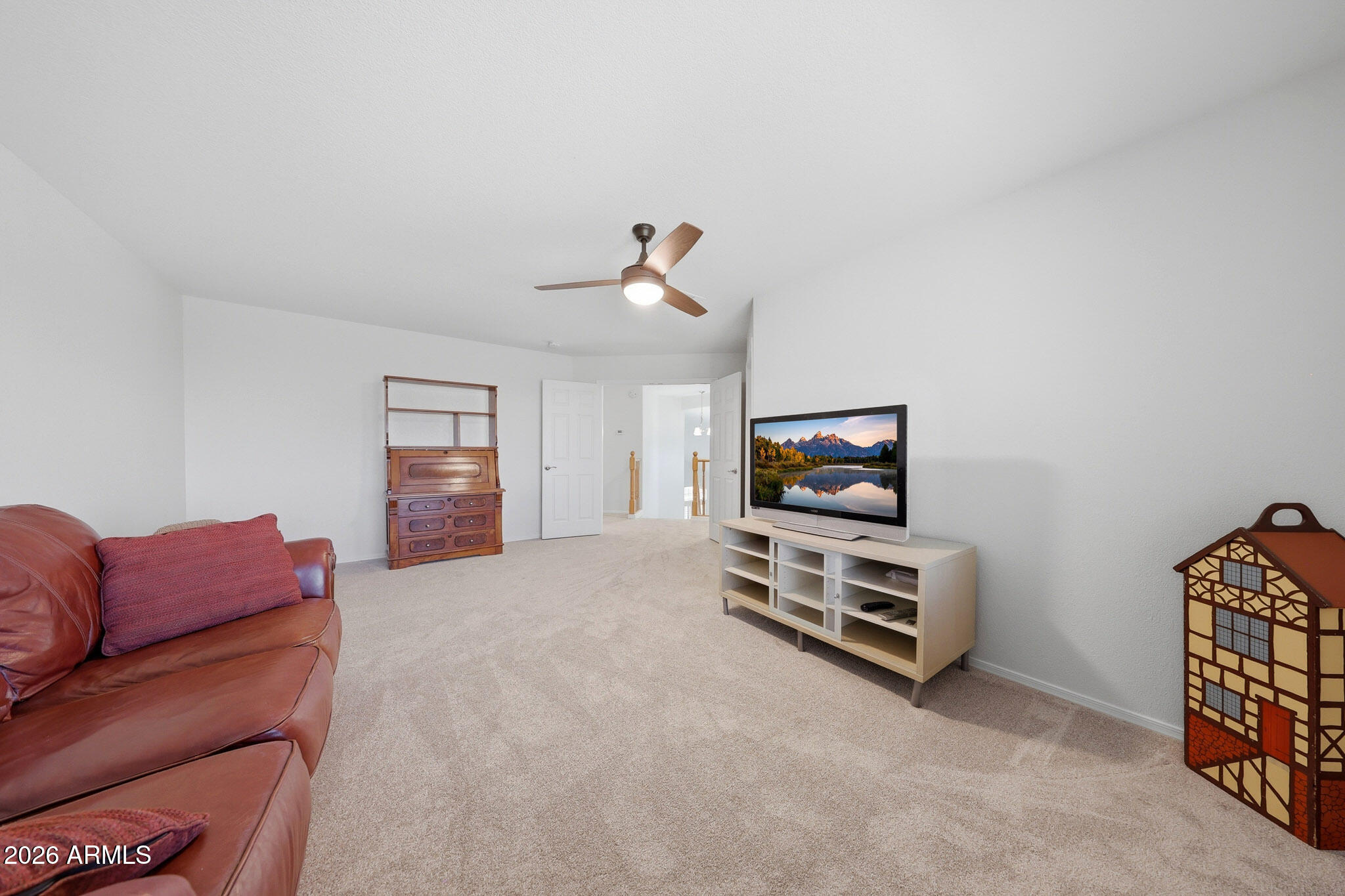 648 South Cholla Street Gilbert, AZ 85233 - Photo 36 of 46 a living room with furniture a flat screen tv and gym equipment