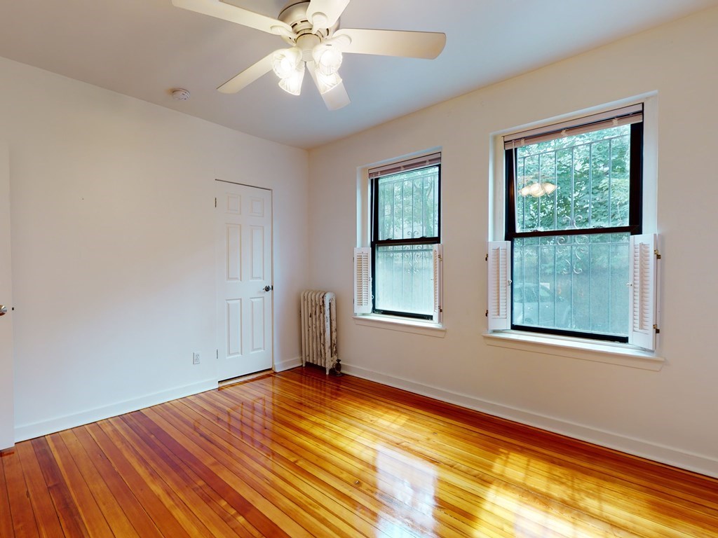 1404 Commonwealth Avenue, Unit 7 Boston, MA 02135 - Photo 14 of 19 a view of empty room with wooden floor and fan