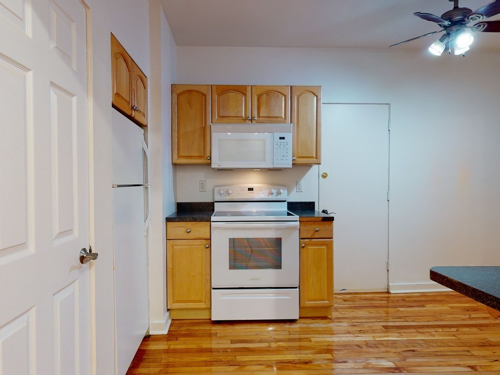 1404 Commonwealth Avenue, Unit 7 Boston, MA 02135 - Photo 8 of 19 a kitchen with stainless steel appliances granite countertop a stove a sink and a refrigerator