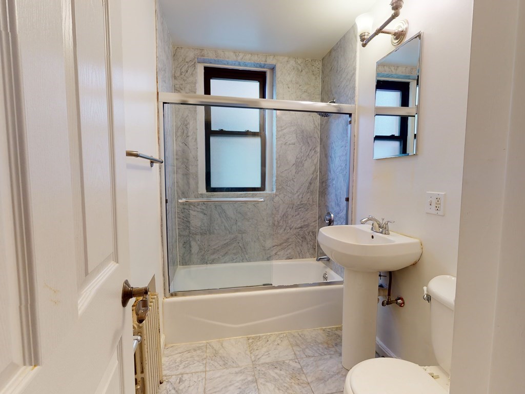 1404 Commonwealth Avenue, Unit 7 Boston, MA 02135 - Photo 10 of 19 a bathroom with a sink a toilet and shower