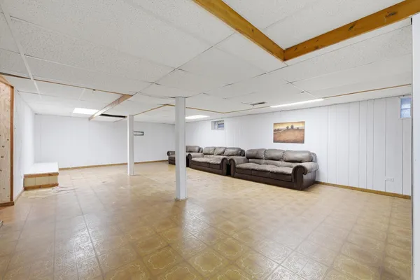 a living room with furniture and a ceiling fan
