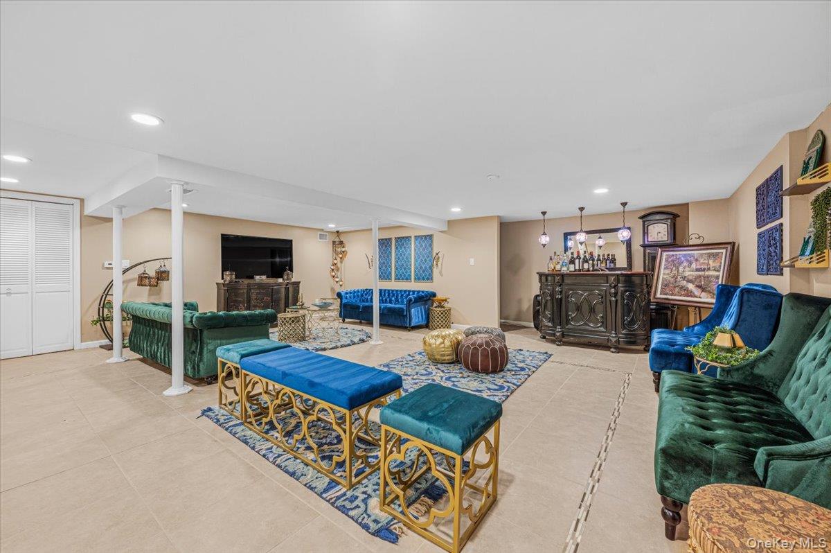 626 Caledonia Road Dix Hills, NY 11746 - Photo 12 of 49 a living room with furniture a flat screen tv and a fireplace