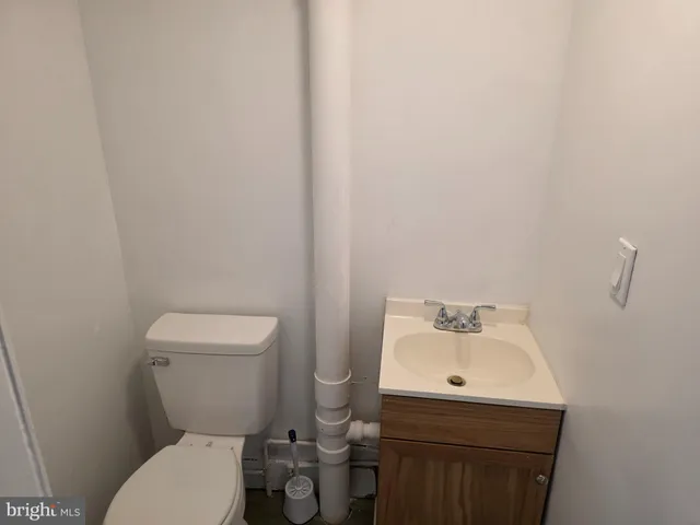 a white toilet sitting next to a bathroom sink