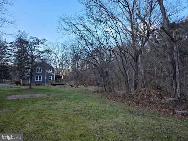 a view of a big yard with a house in the background