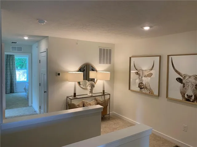 a living room with furniture and a lamp