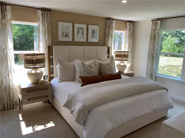 a bedroom with a bed and glass window