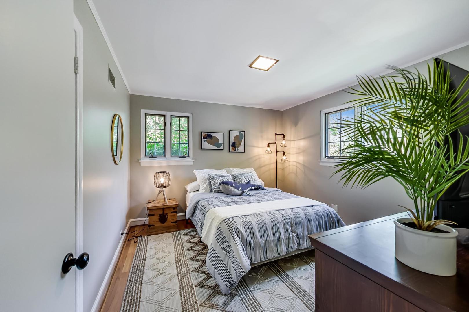 504 Illinois Road Wilmette, IL 60091 - Photo 13 of 43 a bedroom with a bed table flowerpot and window