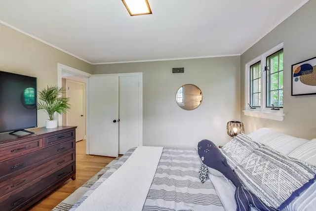 a bedroom with a large bed and a chandelier