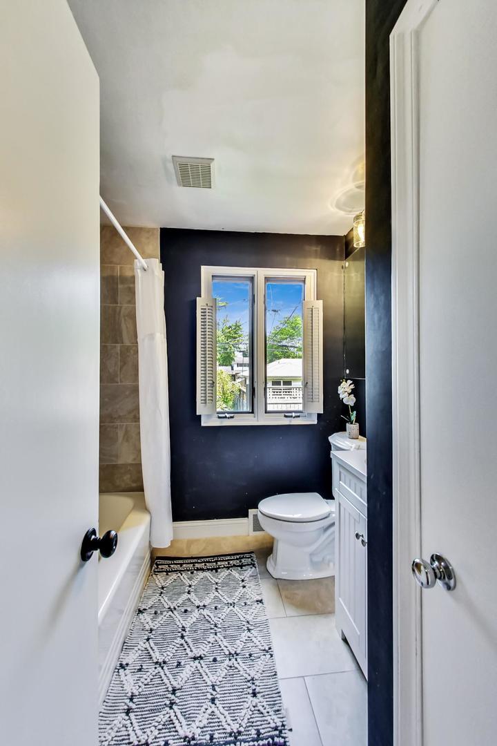 504 Illinois Road Wilmette, IL 60091 - Photo 16 of 43 a bathroom with a toilet a window and tub