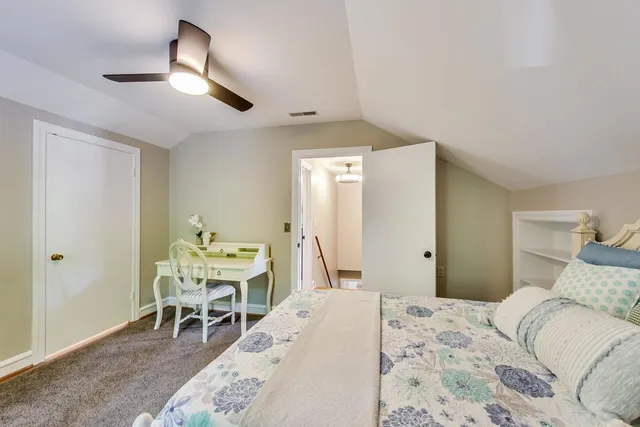 a bedroom with a bed and a table in it