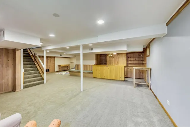 an empty room with white walls and stairs