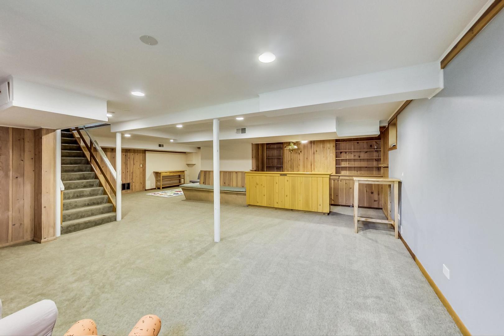 504 Illinois Road Wilmette, IL 60091 - Photo 28 of 43 an empty room with white walls and stairs