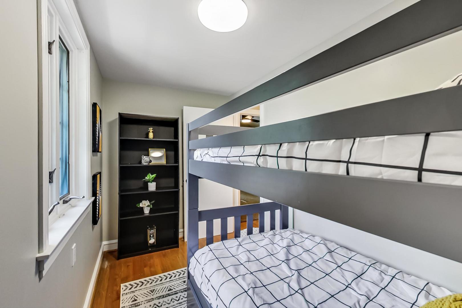 504 Illinois Road Wilmette, IL 60091 - Photo 31 of 43 a bedroom with a bed and a lamp on dresser