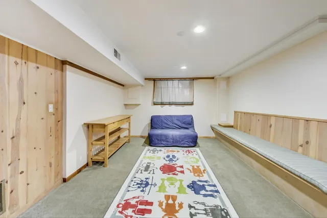 a view of a roof deck with wooden fence and bench