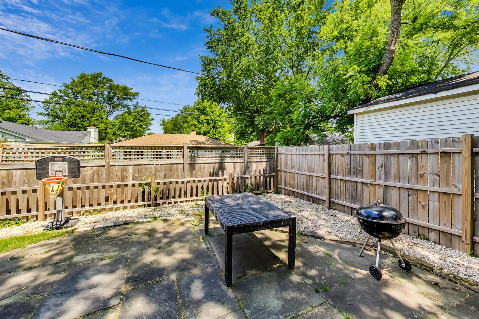 504 Illinois Road Wilmette, IL 60091 - Photo 39 of 43 a view of a roof deck with wooden fence and bench