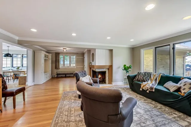 a living room with furniture fireplace and a table