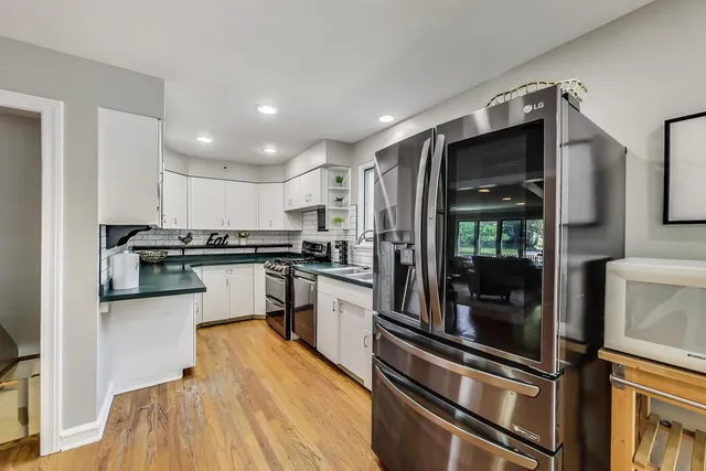 a kitchen with granite countertop stainless steel appliances and wooden cabinets