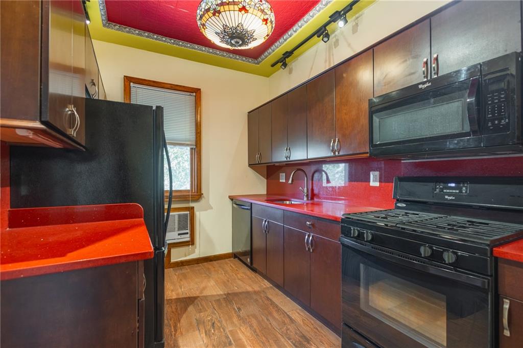 231 Monitor Street Brooklyn, NY 11222 - Photo 16 of 37 a kitchen with stainless steel appliances granite countertop a stove and a microwave